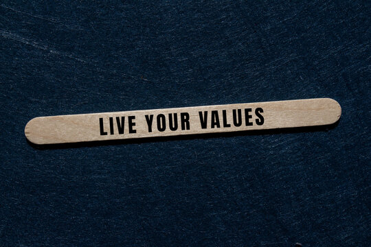 Text live your values on a wooden stick embodying core principles, ethics, integrity, and personal authenticity
