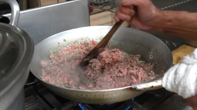 The preparation involves browning ground meat with diced onions in a hot pan and shaping the mixture into uniform patties for restaurant quality meals that provide flavor and consistency for guests
