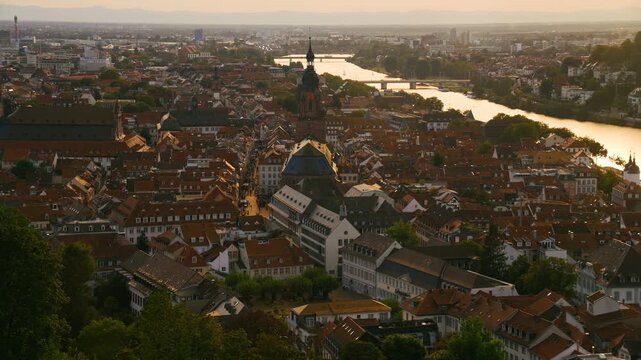 View on the town and Old Bridge in Heidelberg, Germany. A panning cityscape with the Neckar river and the historic downtown Altstadt.