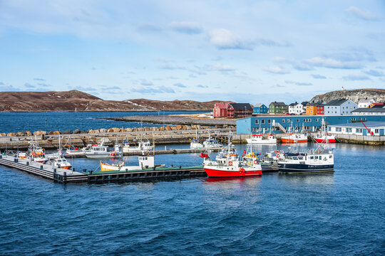 Fishing boats docked at the harbor in Vardo in Norway during a cloudy day