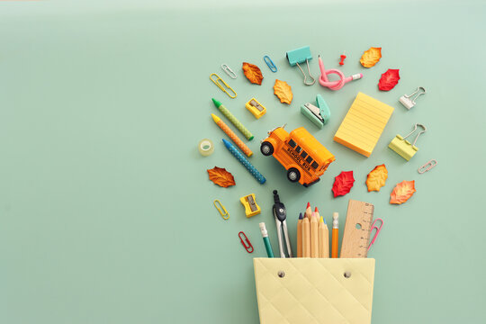 Back to school concept over pastel background. Top view