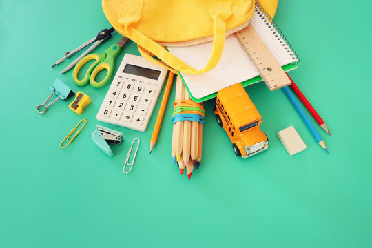 Back to school concept over pastel background. Top view
