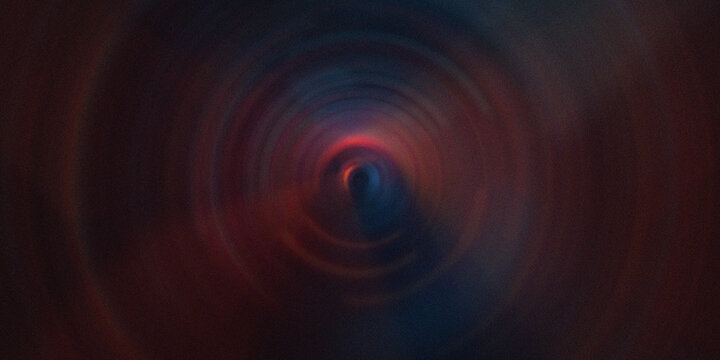 Abstract circular tunnel vortex with glowing red and blue light motion blur effect.