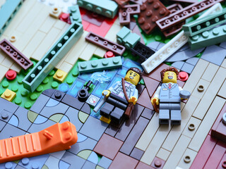 Fototapeta premium Tambov, Russian Federation - June 22, 2026 A pile of Lego pieces with a brick separator and minifigures. Close up.