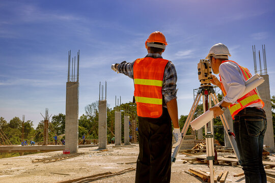 Structural engineer, architect and foreman worker with blueprints discuss, plan working for the outdoors building construction site. Construction collaboration concept
