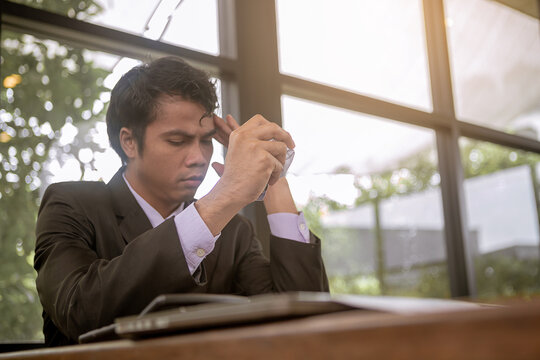Serious businessman crumpled paperwork, nervous from business disappointed and seriously by bad business results. Selected focus