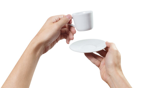 Two hands holding empty white coffee cup and saucer, isolated on transparent cutout background