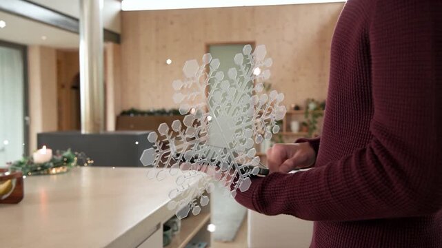 Woman holding tablet, moving device and previewing smart-home snowflake drifting toward camera