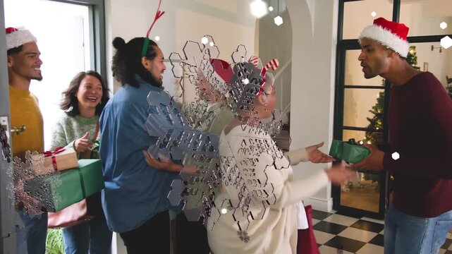 Adults entering open door, exchanging hugs and handing green gifts, celebrating holiday together