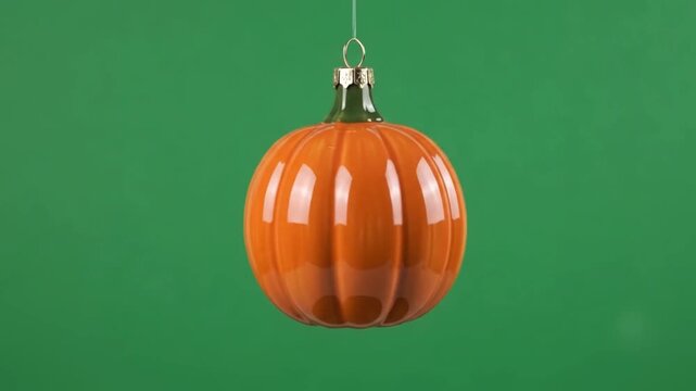 Glossy ceramic pumpkin ornament with a happy face gently rotating in a Halloween chroma animation