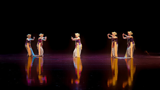 Traditional Female Dancers Performing Mirrored Hand Gestures