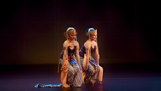 Duo Traditional Dancers Kneeling with Symbolic Stage Props