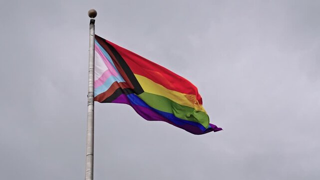 LGBT community. Tolerance and equality. World gay pride. Rainbow gay flag. Pride month. LGBTQ rainbow flag. LGBT rainbow flag waving against sky. Symbol of pride and LGBTQ. Colorful pride flag