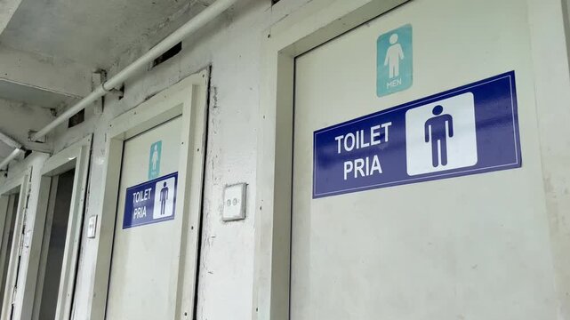 Men's restroom sign on a ship's door or toilet pria in Indonesia language. High resolution video Ideal for navigation, public facilities, signage, restroom guides, architecture, and travel content.