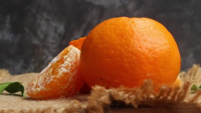 flat lay of peeled oranges on a table with a black background