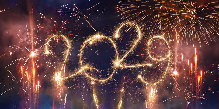 happy new year, new year's eve, silvester, new years eve, sparklers celebration greeting card, new year card - Year 2029 in sparkler font and firework fireworks pyrotechnic, blue night sky background