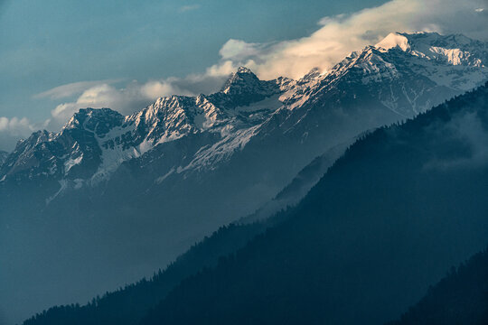Dayara Bugyal Uttarakhand India. Bandarpoonch, Draupadi Ka Danda and other Gangotri Glacial Peaks. Snowy mountain peaks above layered blue hills