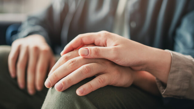 Young couple holding hands and supporting each other