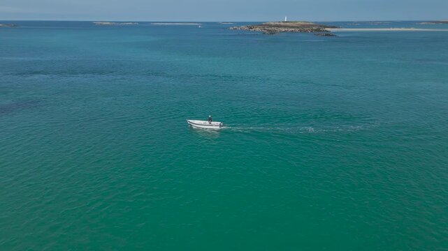Aerial view of a boat moving across the sea near Chausey, Normandy, France