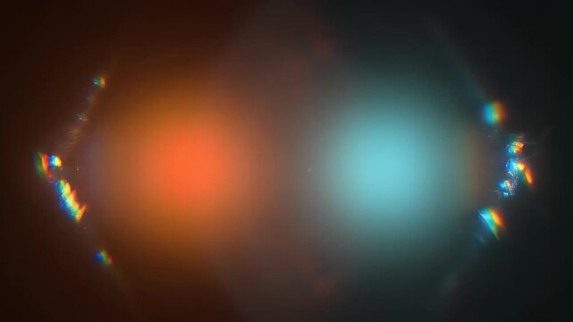 Abstract bokeh lights in orange and blue hues against a dark background
