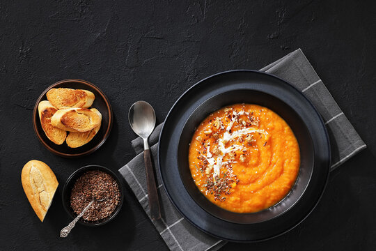 spiced sweet potato soup in a black bowl