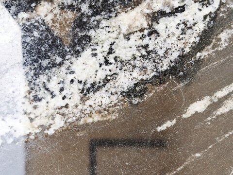 Surface texture of natural black granite marble with white cloud pattern and dark grey veins shiny luxury finish.