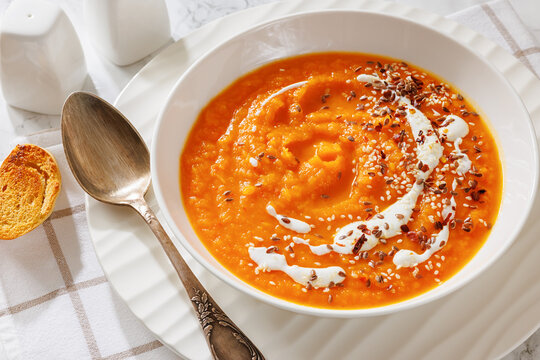 spiced sweet potato soup in a white bowl