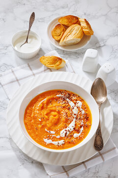 spiced sweet potato soup in a white bowl