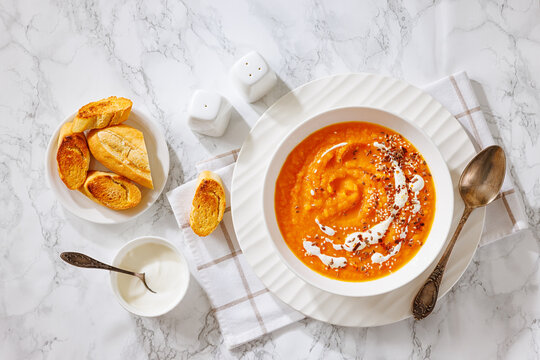 spiced sweet potato soup in a white bowl