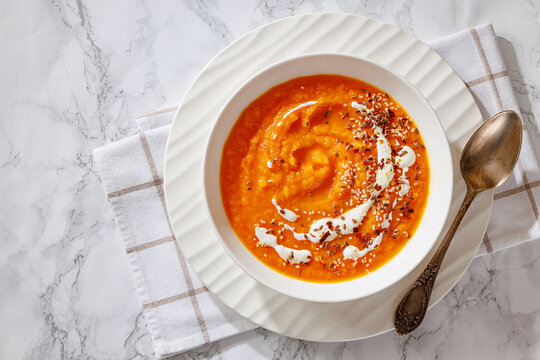 spiced sweet potato soup in a white bowl