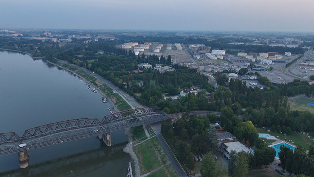 Po river at record low water levels during a severe heatwave, revealing dry riverbed near the Cremona Piacenza border bridge, impacting industry and environment