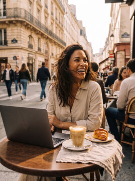 Happy Brunette Woman Laughing Heartily While Working on Laptop at Outdoor Paris Caf&eacute; Terrace