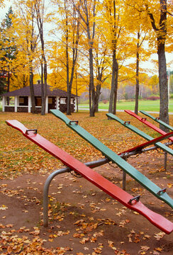Empty teeter totters in Michigan park during autumn