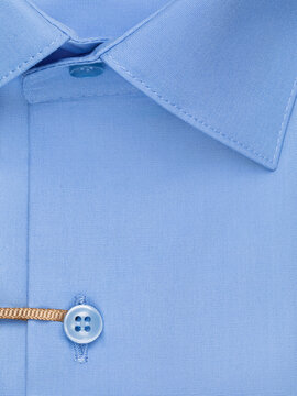 Close up detail of blue men's classic shirt button placket collar and pearl buttons cotton fabric texture top view