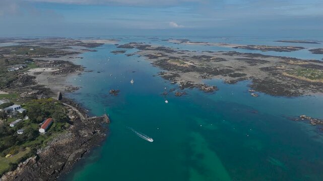 Aerial view of a boat moving across the sea near Chausey, Normandy, France