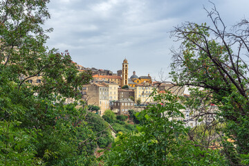 Obraz premium Cervione village church tower rising above hillside town in Corsica