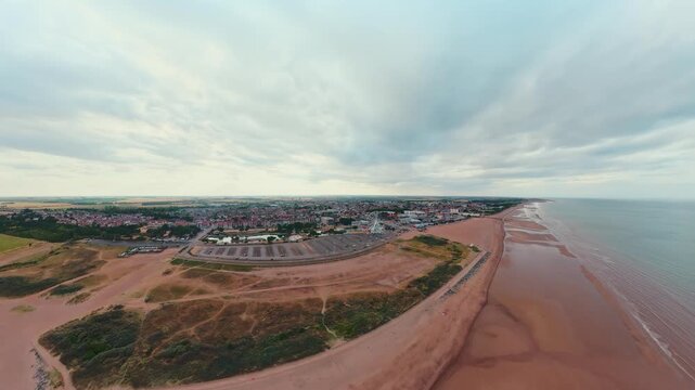 Aerial view of coastal town with wide sandy beach