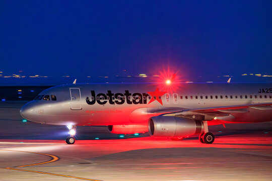 A Jetstar Japan Airbus A320 taking off at night with red lights on April 19, 2025 in Japan.
