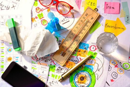 Heat stress and high temperatures in the office.Calendar with business appointments and deadlines, ventilator and thermometer,Business concept beat the clock, overworked, stress.