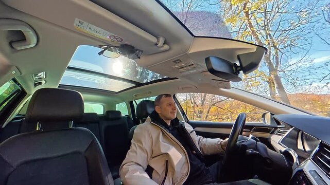 Tiny planet view of a man driving through a sunny residential neighborhood, Creative spherical video shows the car interior houses trees and clear blue sky