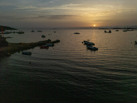 Boats mooring in Piantarella bay during sunset