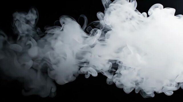 Dramatic Cloud of White Smoke Against Black Background.