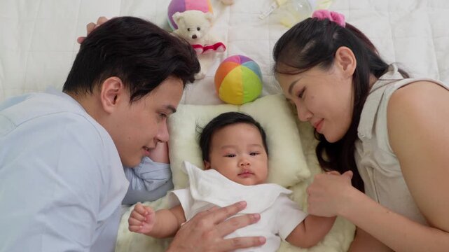 A happy family lovingly nurtures their cute newborn, embracing the innocence of parenthood. Together, they provide infant care, ensuring a healthy start filled with warmth and love. Positive emotion