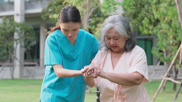 Compassionate Care: A dedicated caregiver assists an elderly woman, supporting her gently as they stroll amidst the serene environment. Reflecting kindness and support.