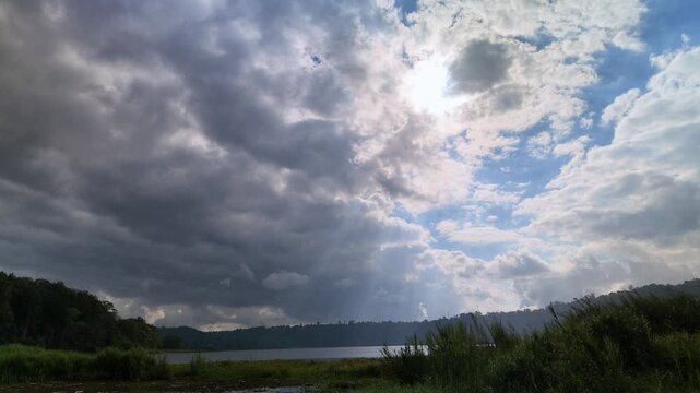 Dramatic Sunbeams Over Lake Buyan in Bali | Scenic Mountain Lake Landscape with Storm Clouds