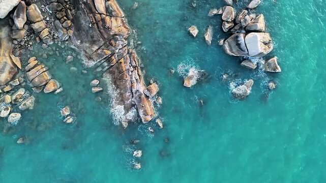 Beautiful Tropical Ocean Flowing Around Ancient Granite Rocks Captured from Above Revealing Stunning Coastal Landscape and Scenic Nature Escape