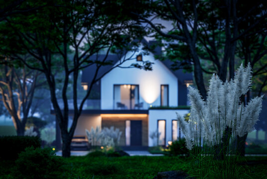 3d rendering of contemporary architectural luxury house exterior at night. Modern Scandinavian style family home, dramatic exterior lighting and garden landscaping at twilight