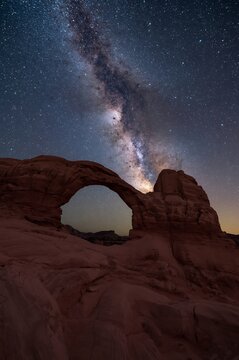Night sky with milky way galaxy above sandstone arch formation in arches national park sandstone landscape