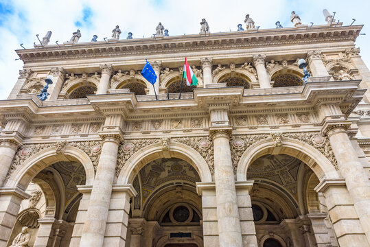 Exterior view of the historic Hungarian State Opera House (Magyar Allami Operahaz) in Budapest. The Neo-Renaissance facade,  People walk by on Andrassy Avenue.
