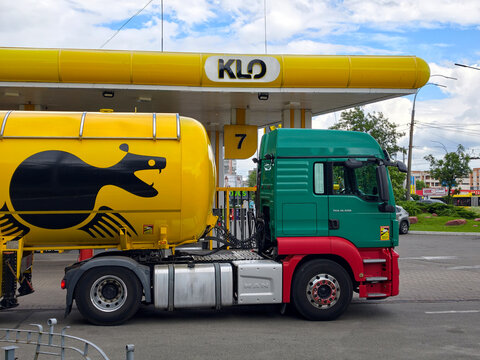 Yellow fuel cistern truck at KLO filling station during petroleum supply operation